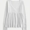 Bequemes Langarm-Babydoll-Oberteil mit Pointelle-Strick Bequemes Langarm-Babydoll-Oberteil mit Pointelle-Strick