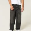 Gewaschene schwarze Baggy-Jeans mit Schlangenstickerei Gewaschene schwarze Baggy-Jeans mit Schlangenstickerei