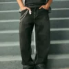 Gewaschene schwarze Baggy-Jeans mit Schlangenstickerei Gewaschene schwarze Baggy-Jeans mit Schlangenstickerei