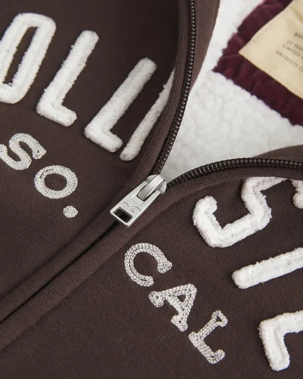 Holiday Vault Release Sherpa-gefütterter Hoodie mit Reißverschluss und Logo-Grafik Holiday Vault Release Sherpa-gefütterter Hoodie mit Reißverschluss und Logo-Grafik