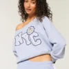 Leichtes Off-Shoulder-Sweatshirt mit NYC-Grafik Leichtes Off-Shoulder-Sweatshirt mit NYC-Grafik