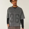 Schweres, baggy geschnittenes, kurzes Football-T-Shirt mit Grafikprint Schweres, baggy geschnittenes, kurzes Football-T-Shirt mit Grafikprint